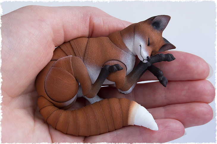 BJD adult red fox is sleeping on the hand